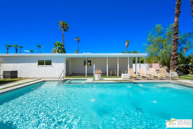 view of pool featuring a patio area and cooling unit