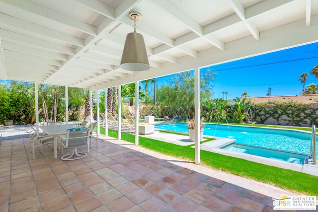 view of swimming pool with ceiling fan, pool water feature, and a patio area