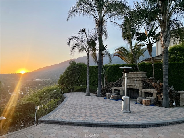 view of home's community with a mountain view and a patio area