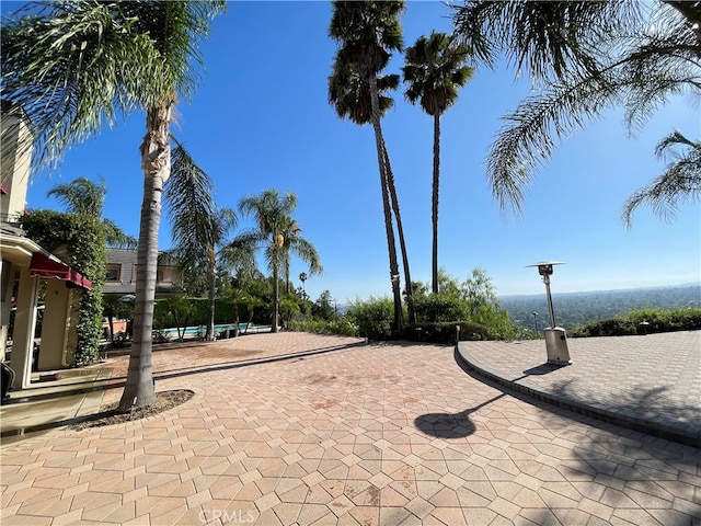 surrounding community featuring a swimming pool and a patio