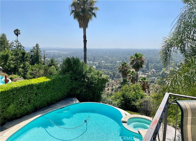 view of pool with an in ground hot tub