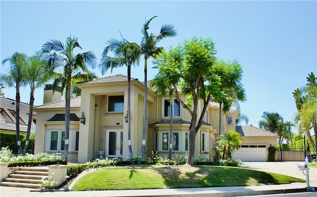 view of front of house with a front yard and a garage