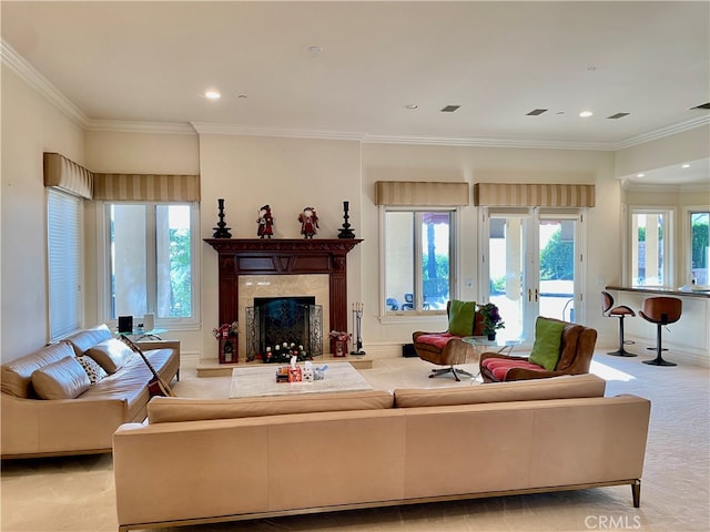 living room featuring a premium fireplace, crown molding, and light colored carpet