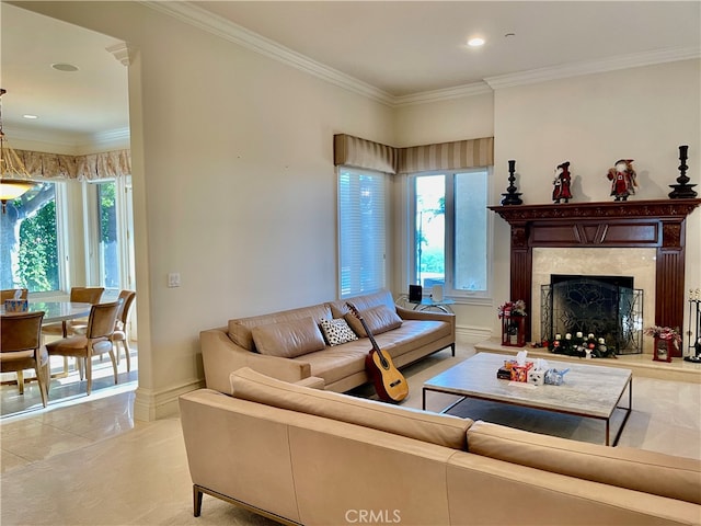 living room featuring a premium fireplace, ornamental molding, and a healthy amount of sunlight