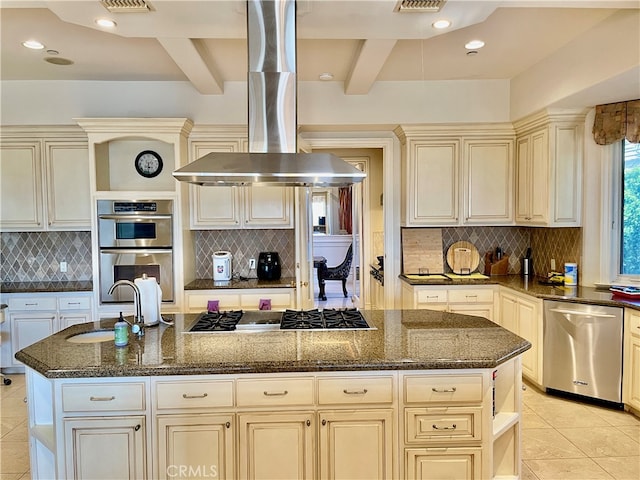 kitchen featuring island range hood, beam ceiling, dark stone counters, sink, and appliances with stainless steel finishes