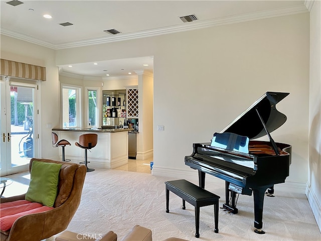 miscellaneous room featuring bar area, crown molding, light colored carpet, and french doors