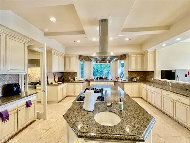 kitchen with kitchen peninsula, an island with sink, and island range hood