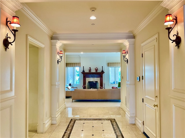 hall featuring ornamental molding and light tile patterned floors