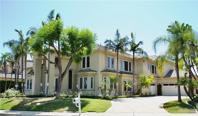 view of front facade with a front yard and a garage