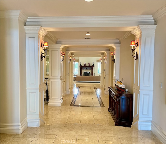 hallway with crown molding and ornate columns