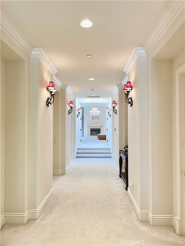 hallway with ornamental molding and carpet flooring