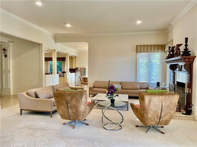 carpeted living room featuring decorative columns and ornamental molding