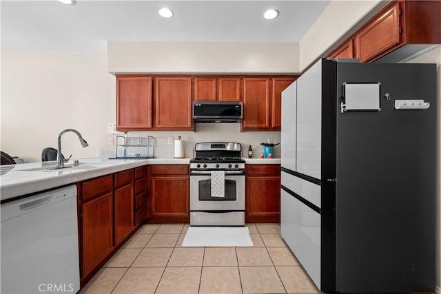 kitchen featuring sink, light tile patterned flooring, and appliances with stainless steel finishes