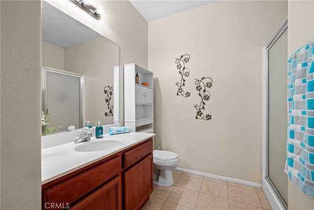 bathroom with tile patterned flooring, vanity, toilet, and a shower with shower door