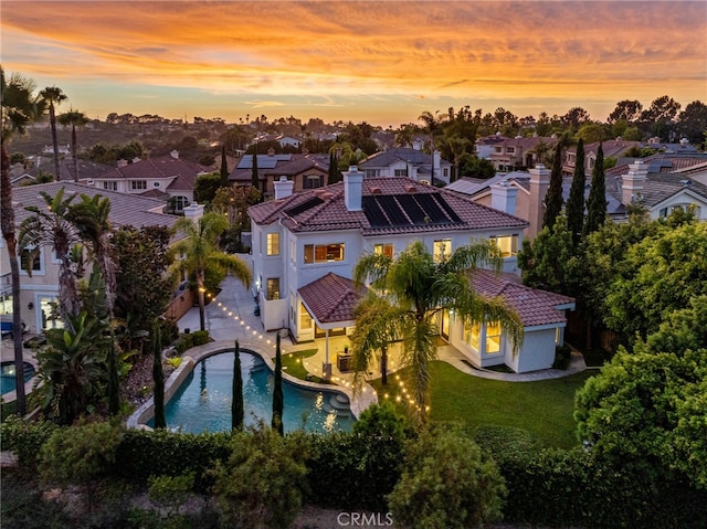 aerial view at dusk with a water view