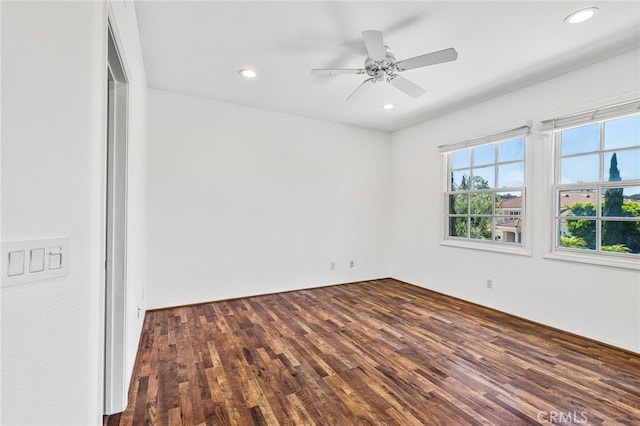 empty room featuring ceiling fan and dark wood-type flooring