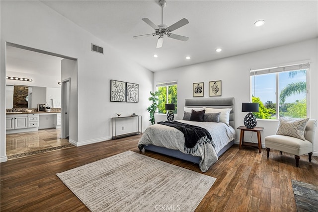 bedroom featuring ceiling fan, dark hardwood / wood-style floors, ensuite bathroom, and high vaulted ceiling