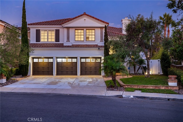 mediterranean / spanish-style home featuring a garage