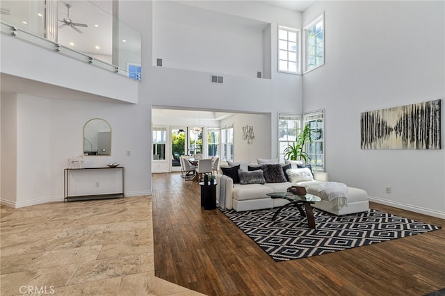 living room featuring a wealth of natural light, a high ceiling, and hardwood / wood-style flooring