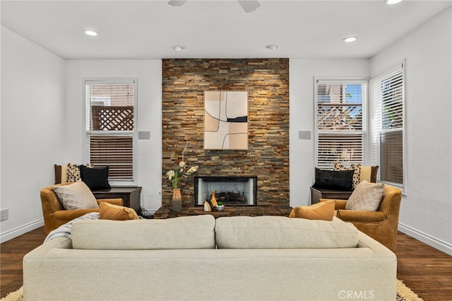 living room with a fireplace, dark hardwood / wood-style floors, and ceiling fan