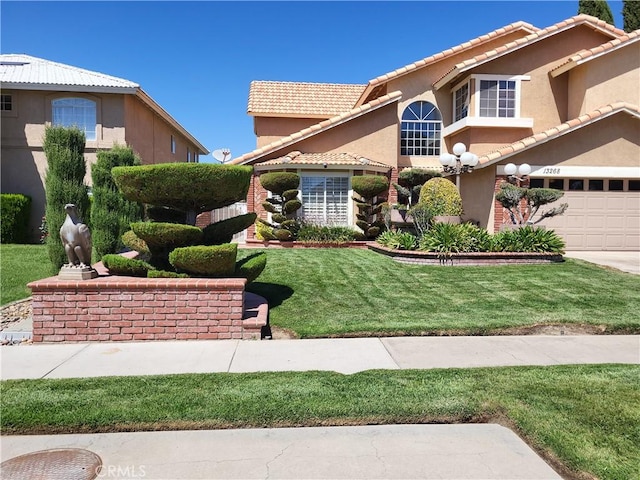 view of front of home with a garage and a front lawn