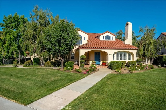 mediterranean / spanish house featuring a porch and a front lawn