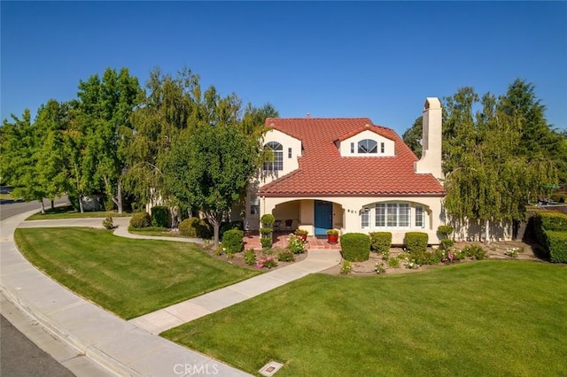 mediterranean / spanish house featuring a front lawn