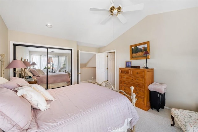 carpeted bedroom with ceiling fan, a closet, and lofted ceiling