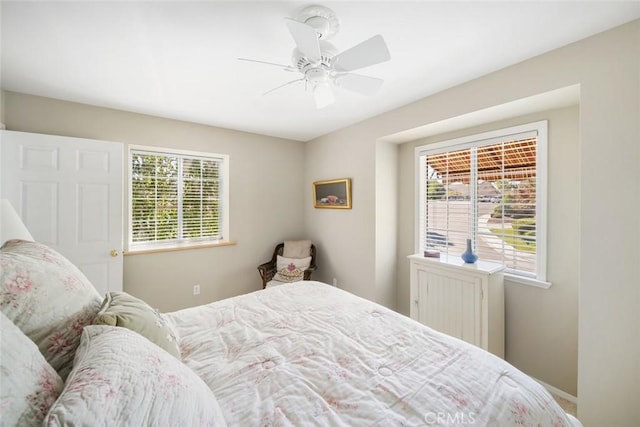 bedroom with multiple windows and ceiling fan