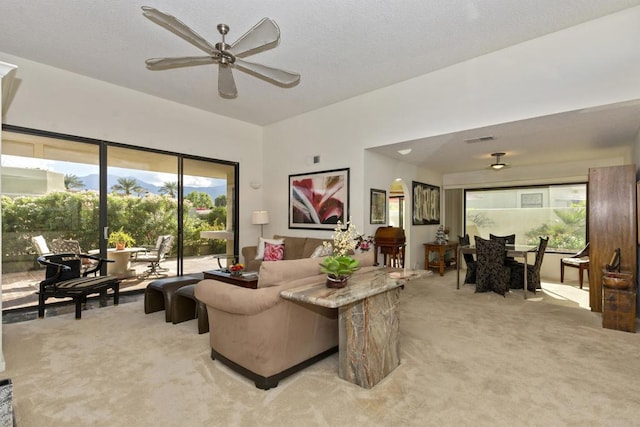 carpeted living room featuring ceiling fan