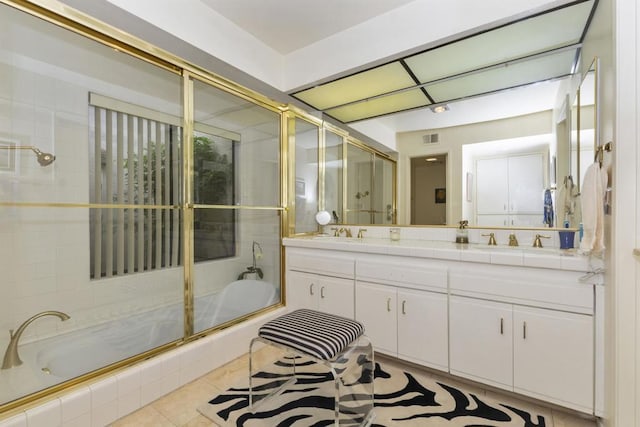 bathroom featuring tile patterned floors, vanity, and enclosed tub / shower combo