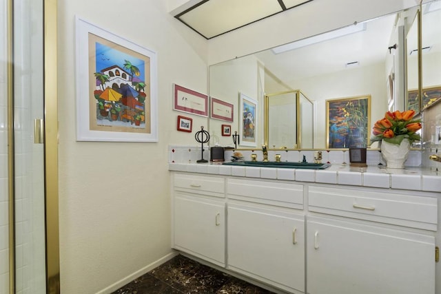 bathroom with vanity and a shower with door