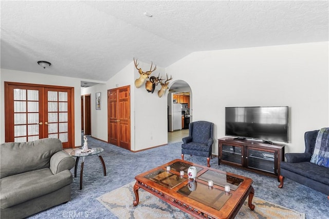 living room with carpet, lofted ceiling, a textured ceiling, and french doors