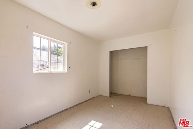 unfurnished bedroom with a closet