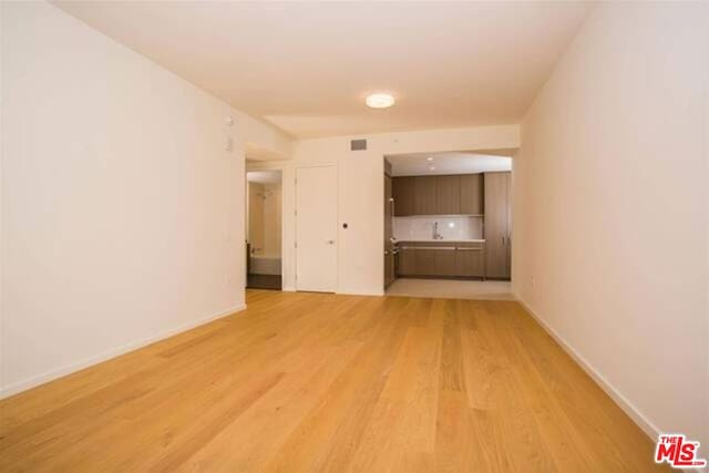 spare room with light hardwood / wood-style flooring