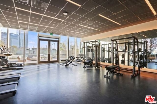 gym with a wall of windows