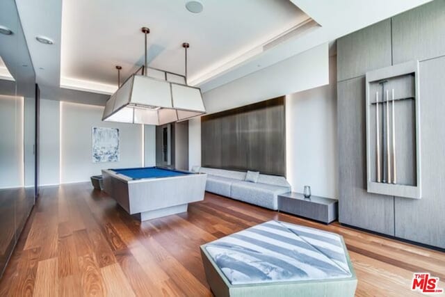 recreation room featuring hardwood / wood-style flooring, billiards, and a raised ceiling