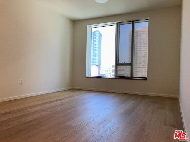 unfurnished room featuring hardwood / wood-style floors