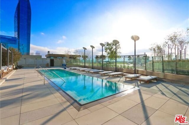 view of swimming pool with a patio