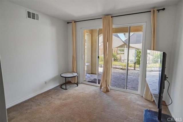 entryway featuring light colored carpet