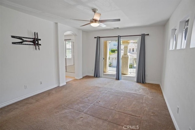 carpeted spare room featuring ceiling fan