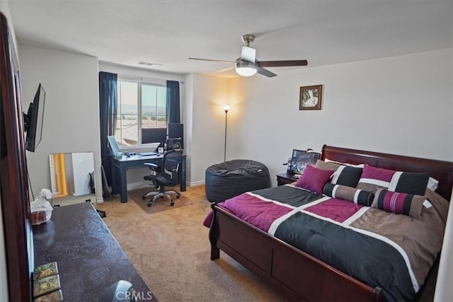 bedroom with ceiling fan and light carpet