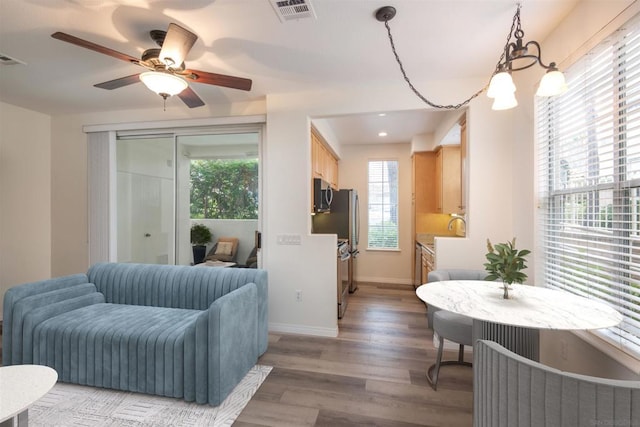 bedroom with light hardwood / wood-style floors, sink, and ceiling fan