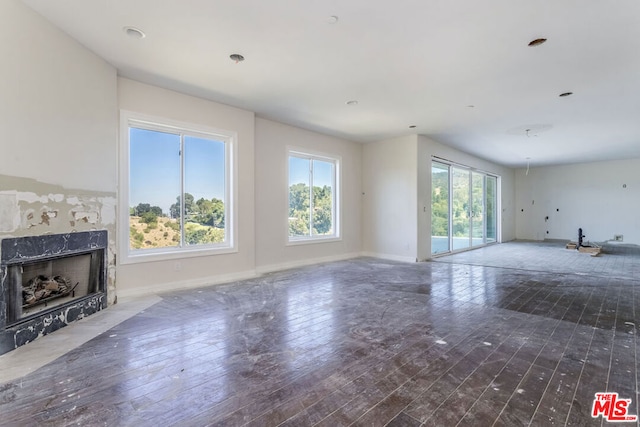 unfurnished living room with a fireplace and dark hardwood / wood-style flooring