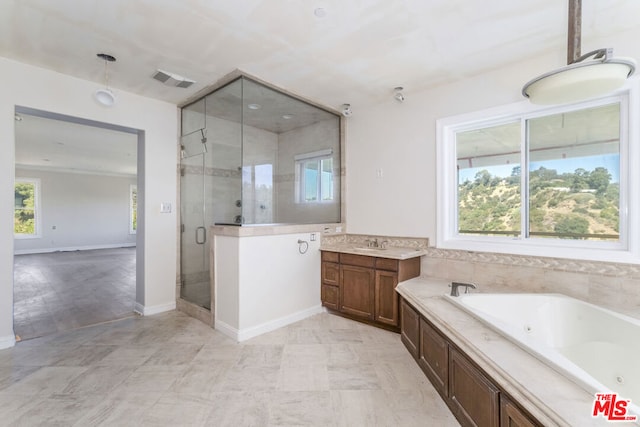 bathroom with vanity, plus walk in shower, and a healthy amount of sunlight