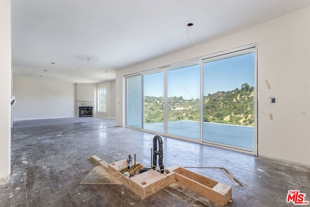 unfurnished living room with dark hardwood / wood-style flooring