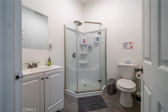 bathroom with vanity, toilet, tile patterned flooring, and an enclosed shower