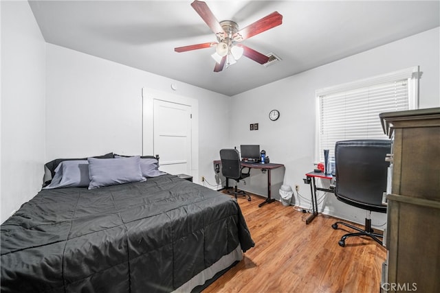 bedroom with wood-type flooring and ceiling fan