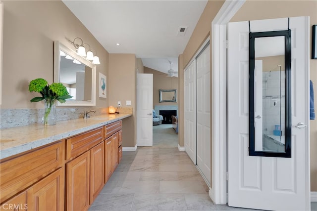 bathroom featuring vanity and a shower with door