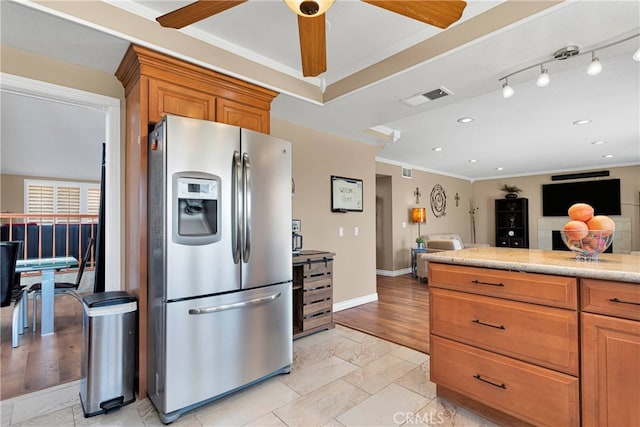 kitchen featuring ornamental molding, light wood-type flooring, ceiling fan, and stainless steel fridge